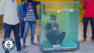 Most Rubiks cubes solved underwater  Guinness World Records [upl. by Analart500]