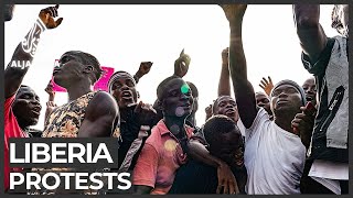 Liberian police fire tear gas water cannon to clear protesters [upl. by Burgwell]